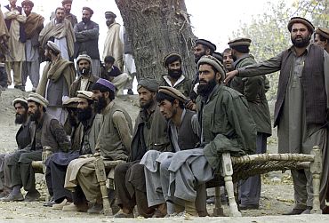 File picture show captured Afghan al Qaeda members sitting on a bench as they are presented to the media in Tora Boraa