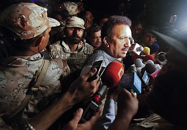 Pakistan's Interior Minister Rehman Malik speaks to the media outside Mehran naval aviation base, which was attacked by militants, in Karachi