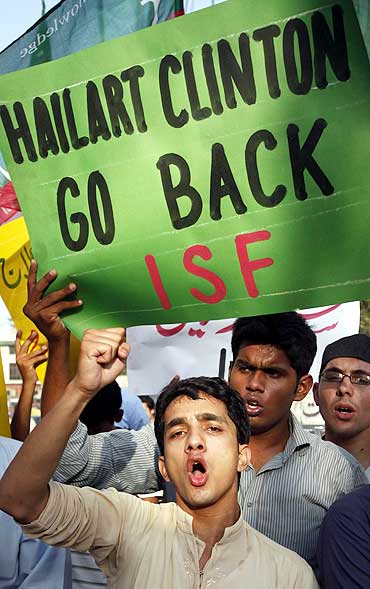 Supporters of Tehreek-e-Insaf hold placards as they shout anti-American slogans during a protest rally against the visit of US Secretary of State Hillary Clinton in Lahore