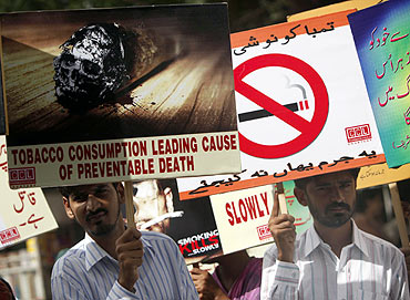 Men hold placards to observe World No Tobacco Day rally organised by The Pakistan Islamic Medical Association