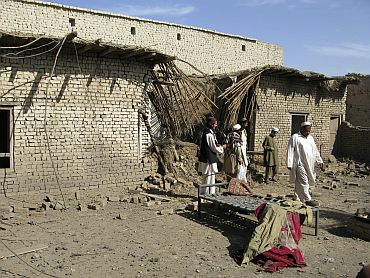 Tribesmen gather at the site of a missile attack on the outskirts of Miranshah in Pakistan in 2008. Suspected US drones fired missiles into this Pakistani village, killing at least seven people, residents and an official said.