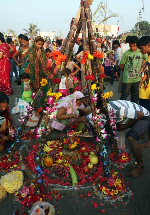 Devotees at Juhu beach in Mumbai offer prayers to the Sun God