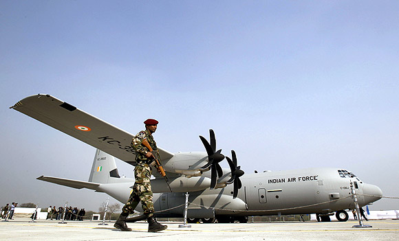 A soldier walks past the C-130J-30 Super Hercules Aircraft during an induction ceremony at the Hindan Air Force Station