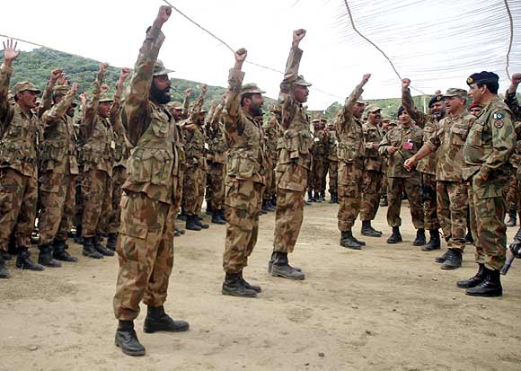 Pakistani soldiers shout 'Allah-hu-Akbar' (God is Great) as Army Chief General Ashfaq Parvez Kayani looks on during  a joint military exercise conducted by Pakistan and Saudi Arabia