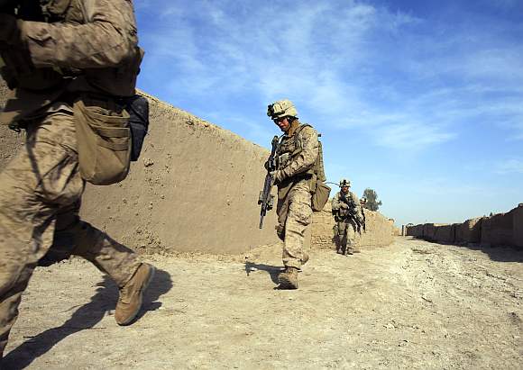US Marines from Bravo Company of the 1st Battalion, 6th Marines, run during an operation in the town of Marjah, in Nad Ali district of Helmand province in Afghanistan