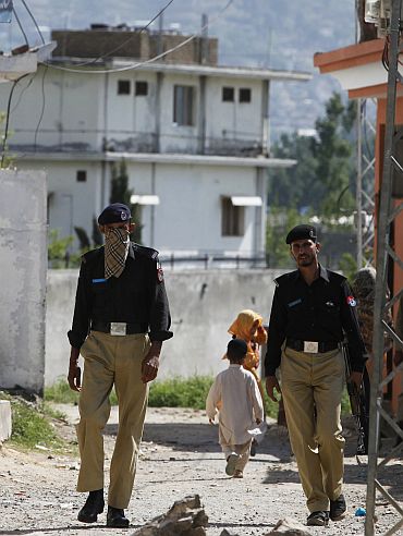 Policemen patrol a street near the compound where Al Qaeda leader Osama bin Laden was killed in Abbottabad