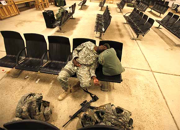 A member of the US Air Force rests in a hall, before flying to the US, at al-Asad air base in Iraq's western province of Anbar