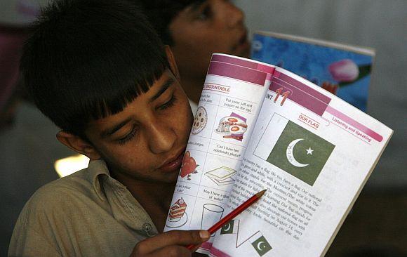 A boy displaced by the 2009 floods attends school at the UNHCR Jalala camp in Mardan district of Pakistan