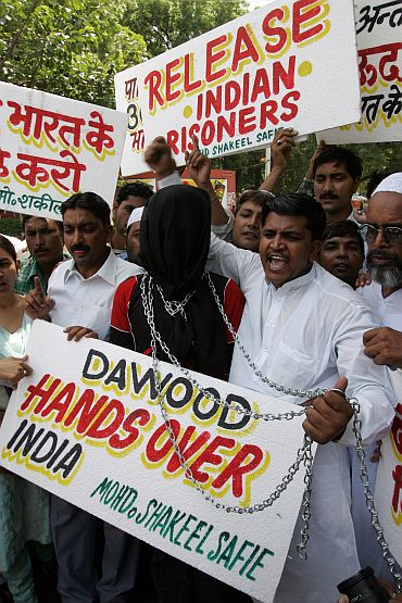 Muslims hold placards and shout slogans during a protest in New Delhi demanding that Pakistan must handover Dawood Ibrahim