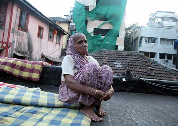 Victim Haresh Gohil's paternal grandmother sits in the backdrop of the Chabad House