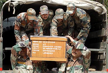 Indian Army soldiers carry the coffin of an officer who was killed in a clash in Kashmir