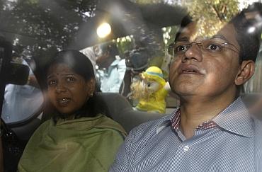 DMK MP Kanimozhi and Kalaignar TV managing director Sharad Kumar leave a court in New Delh