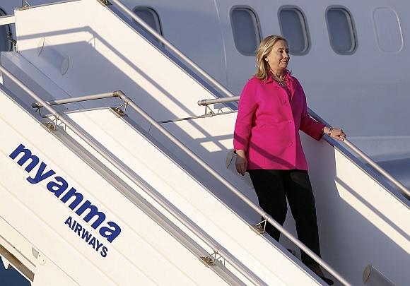 Clinton steps out of her plane after landing in Myanmar's capital Naypyitaw