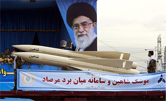 A military vehicle carrying the Shaheen missile, part of Iran's medium range anti-aircraft air defence system Mersad, drives past a picture of Iran's Supreme Leader Ayatollah Ali Khamenei