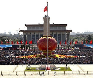 Tourists gather around a giant red lantern on display at Beijing's Tiananmen Square