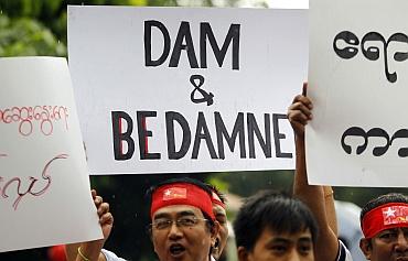 Kachin people from Myanmar hold placards during a protest in New Delhi