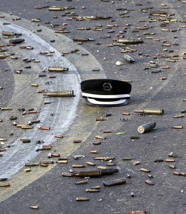 A hat that belonged to a member of Gaddafi's forces is seen on the ground amidst spent bullet cartridges during heavy clashes against anti-Gaddafi forces outside the state security compound in Sirte