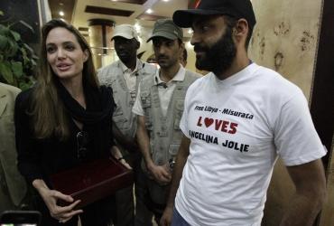 Angelina Jolie receives a plaque from residents at her hotel in Misrata during her visit to the war-torn city