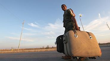 A Palestinian walks past the Rafah border crossing between Egypt and the Gaza Strip, in Rafah city, about 350 km northeast of Cairo