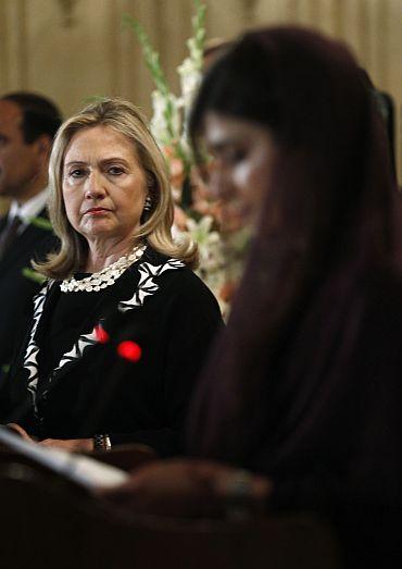 US Secretary of State Hillary Clinton listens to Pakistan's Foreign Minister Hina Rabbani Khar speak during a joint press availability in Islamabad on October 21.