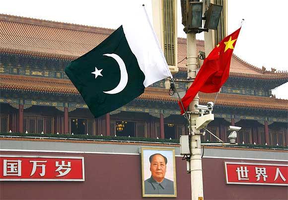 A Pakistan national flag flies alongside a Chinese national flag in front of the portrait of Chairman Mao Zedong on Beijing's Tiananmen Square