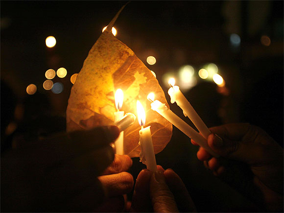 Residents hold candles during a vigil held for 26/11 victims.