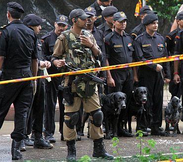 Commandos and police officers stand guard near the site of the Delhi HC bomb blast