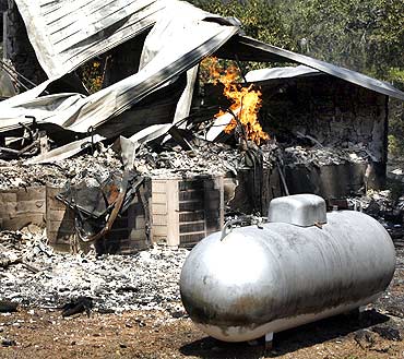 A gas leak continues to burn after a home was destroyed in wildfire near Bastrop, Texas