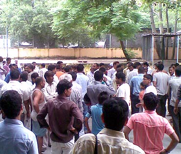 People wait outside the mortuary