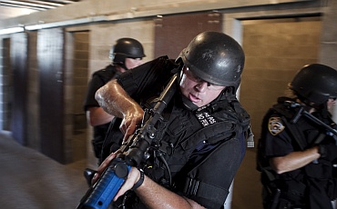 NYPD Emergency Service Unit officers practice urban assault tactics during a training session in New York