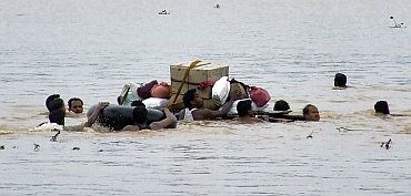 Flood-affected people move their belongings to safer places in Kanasa, Puri