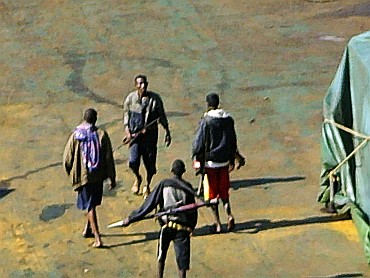 Pirates are seen on board the deck of the Chinese ship Zhenhua 4 in the Gulf of Aden