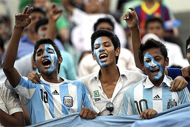 Fans cheer the Argentina soccer team during a practice session in Dhaka