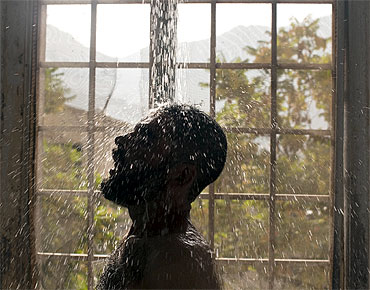 An Afghan drug addict takes a cold shower as part of his treatment in Kabul