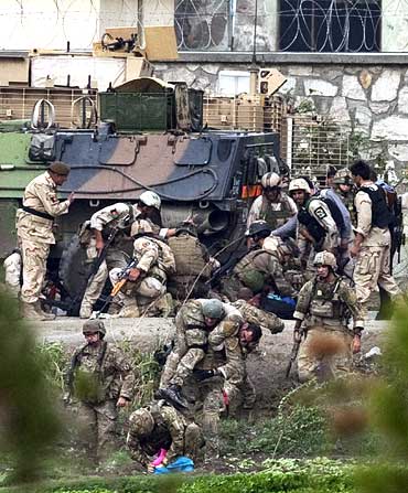 NATO and Afghan troops attend to casualties during a battle with Taliban insurgents