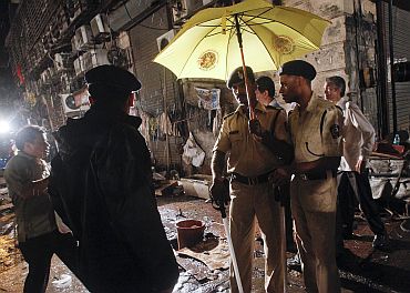 Policemen stand guard at the site of an explosion near the Opera House in Mumbai