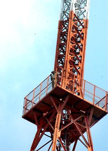 Home Guard Srinivas Naiks climbs atop the AIR tower in Hyderabad