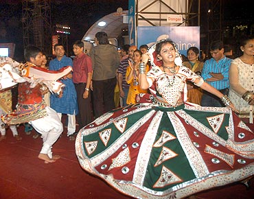 A reveller show off her vibrant outfit at the Sankalp garba dance at Goregaon Sport Club in Mumbai