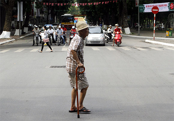 A voter walks on a street to a polling station in Hanoi, Vietnam