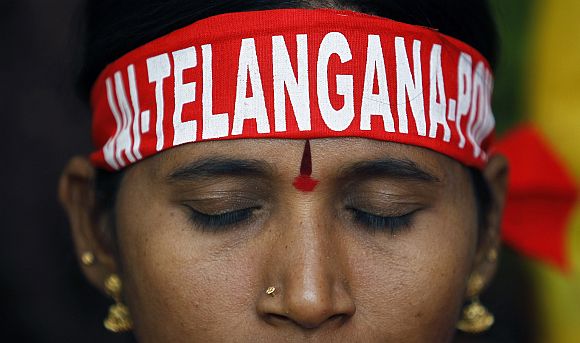 A pro-Telangana supporter listens to a speaker during a protest in New Delhi