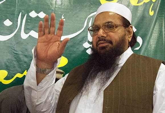 Hafiz Mohammad Saeed, head of Jamaat-ud-Dawa and founder of Lashkar-e-Tayyiba, waves to the media after a news conference in Rawalpindi near Islamabad April 4