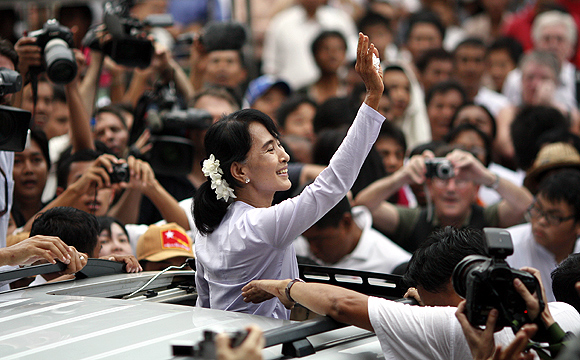 Myanmar's pro-democracy leader Aung San Suu Kyi leaves her party office