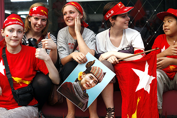 Tourists in front of the NLD office cheer as election results are announced.