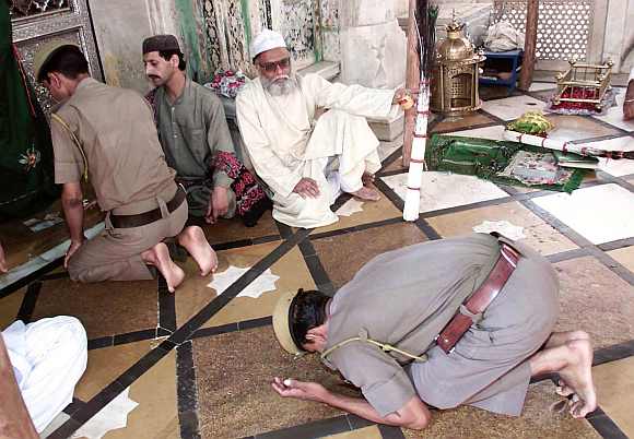 Policemen pay their respects at the shrine of Sufi saint Khwaja Moinuddin Chisty