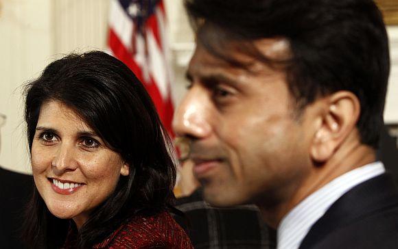 Nikki Haley and Bobby Jindal are seated together at the National Governors Association in the State Dining Room of the White House in Washington, DC