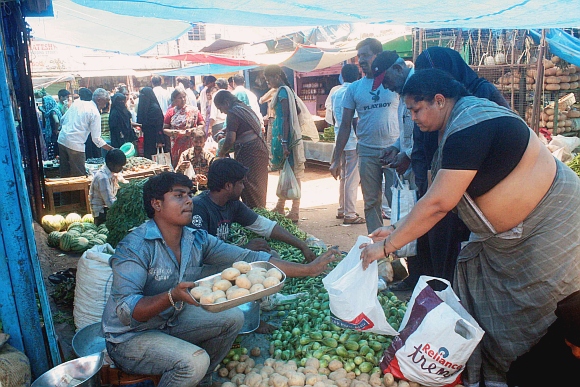 People buying vegetables and essentials at the Charminar to Madina circle