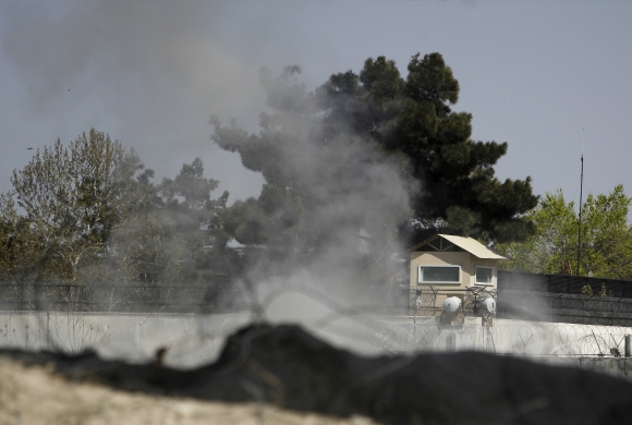 Smoke rises from a tower belonging to the British embassy after gunmen launched multiple attacks in Kabul