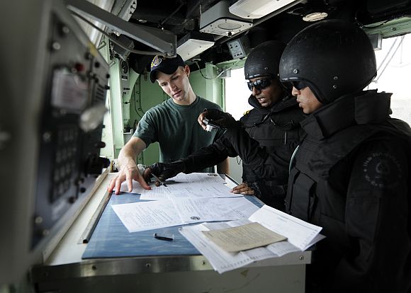 Ensign Livy Coe shows documentation to members of the visit, board, search and seizure team from the Indian navy guided-missile destroyer INS Ranvijay (DDG 55) aboard the Ticonderoga-class guided-missile cruiser USS Bunker Hill (CG 52) during an Exercise Malabar 2012 boarding exercise. Malabar is a scheduled naval training exercise conducted to advance multinational maritime relationships and mutual security issues.