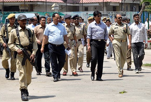 Police personnel supervise the security set-up ahead of PM Singh's visit to Guwahati on April 20
