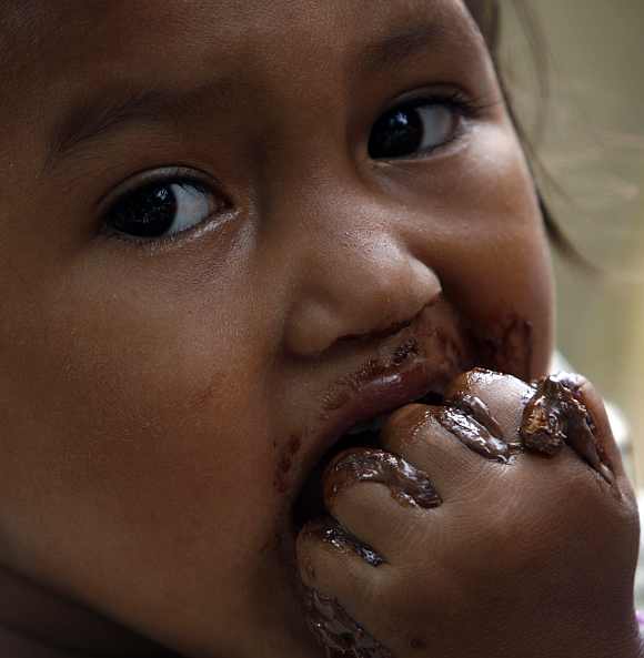 A child eats chocolate in the Korong Patamuan village, in Pariaman district, Indonesia